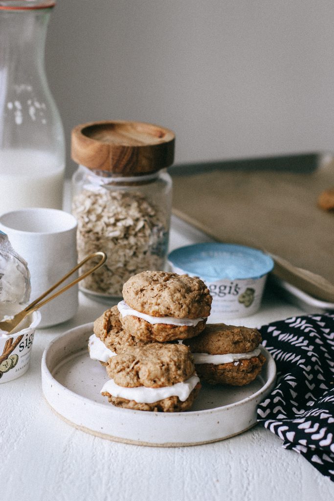 Oatmeal cookie sandwiches with yogurt filling on a white plate 