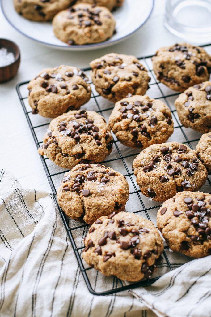 Chocolate chip cookies on a cooling rack with striped napkin