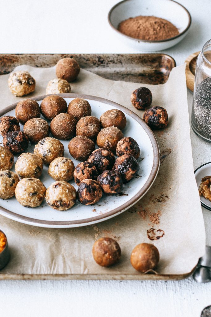 raw energy balls on a plate on a baking tray