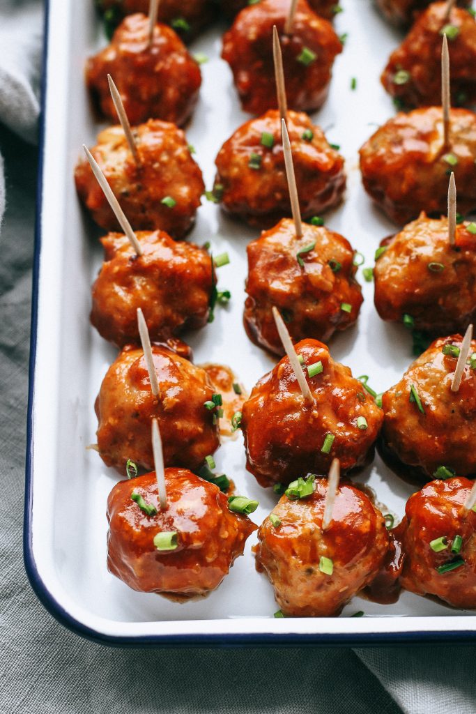 cocktail meatballs with toothpicks on a white tray