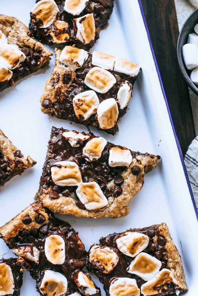 smores bars on white tray on wood cutting board