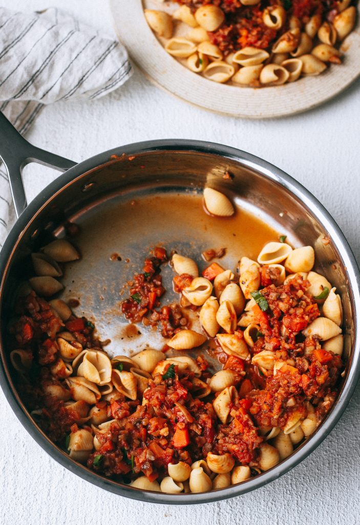 pasta shells with vegan bolognese sauce in a pot 