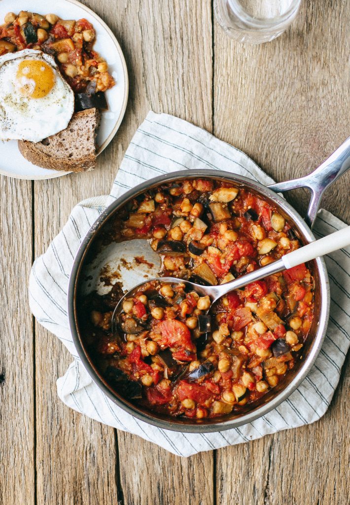 zucchini and eggplant and chickpea sauce in a pot with spoon