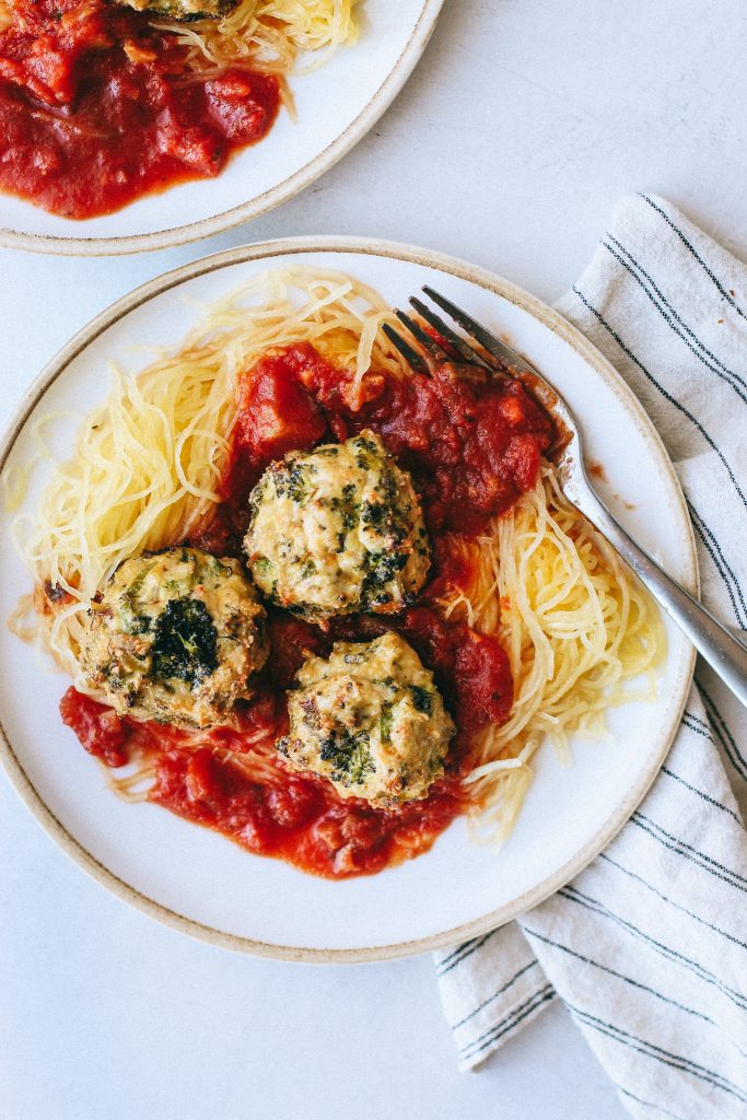 broccoli chicken meatballs with spaghetti squash and marinara on plate with fork