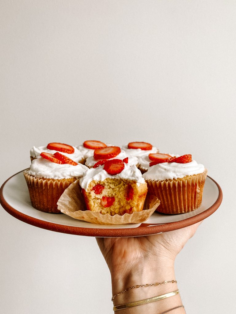 strawberry shortcake cupcakes on a plate in the air