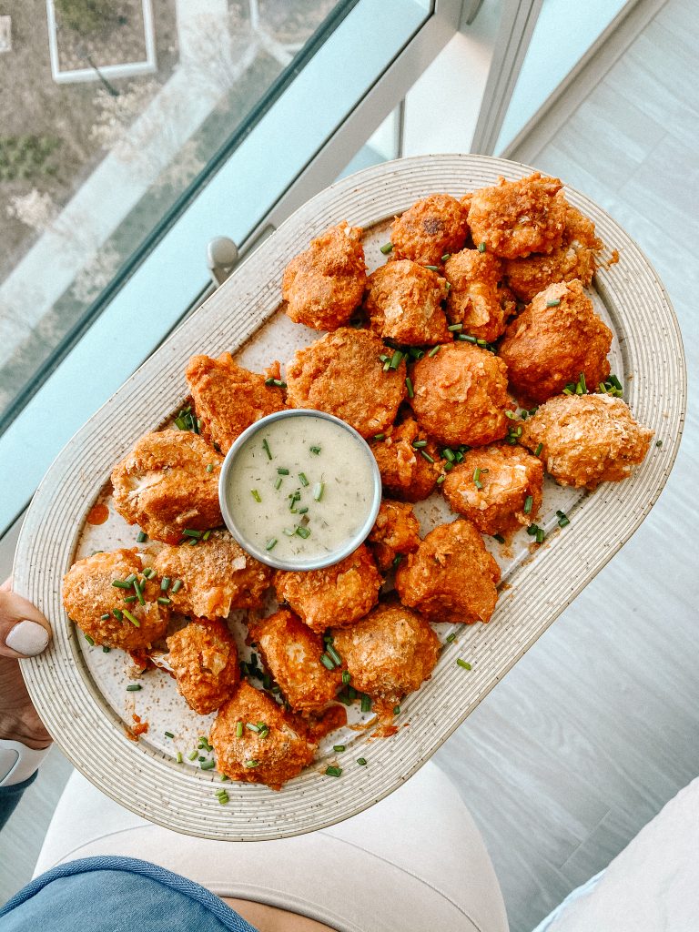 buffalo cauliflower wings on a plate with a small bowl of ranch
