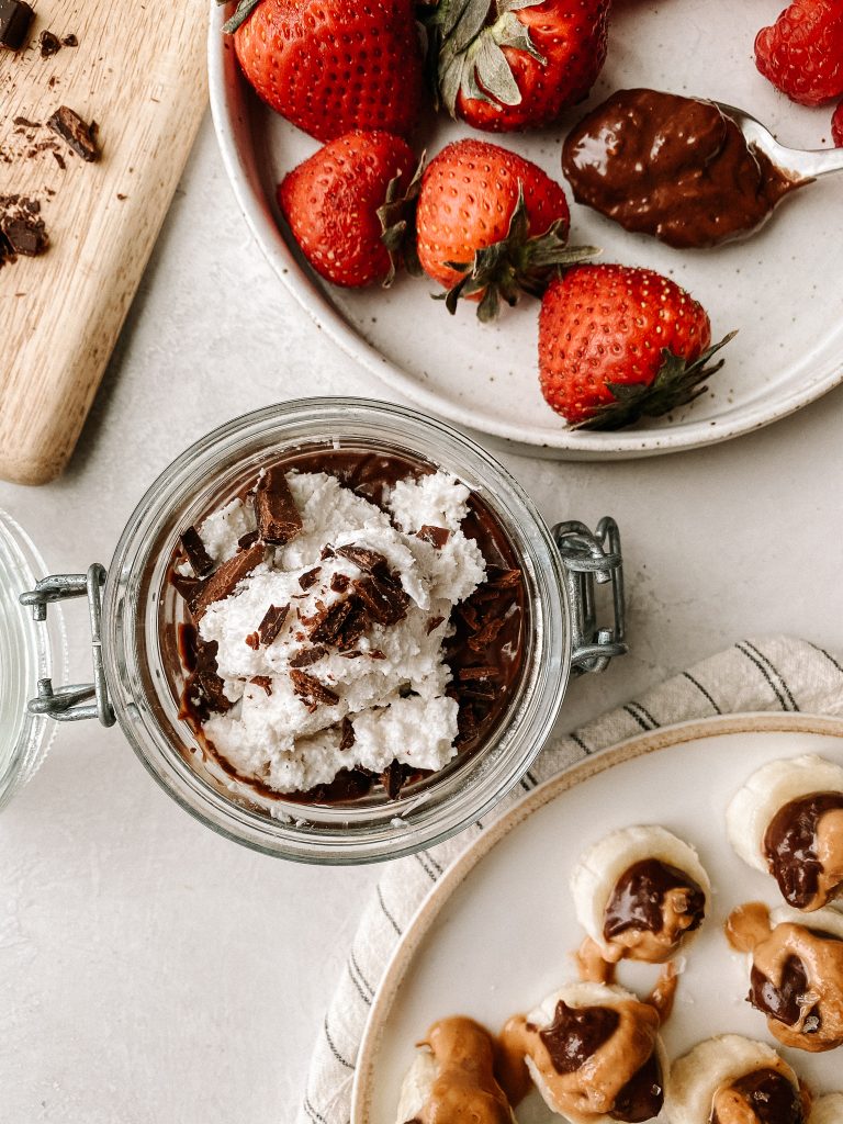 plate of berries with chocolate pudding on spoon, chocolate pudding in jar with cool whip