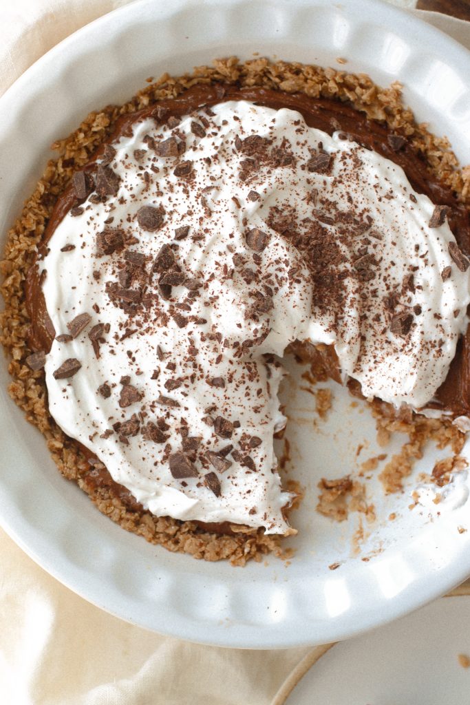 chocolate mousse pie with cool whip topping in a pie dish