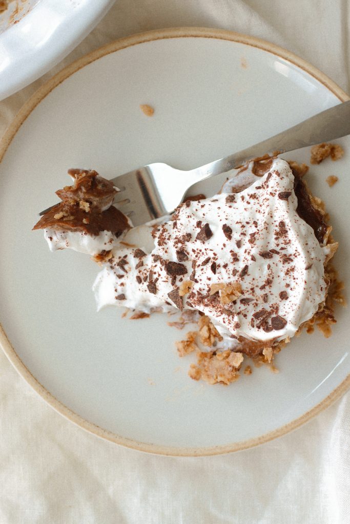 chocolate mousse pie with cool whip topping on a plate with a fork