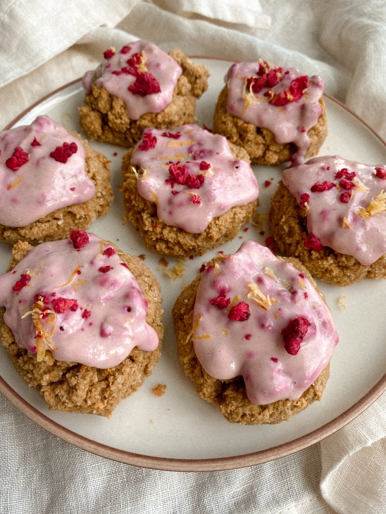 cookies with raspberry yogurt frosting on plate
