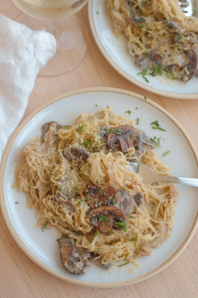 mushroom spaghetti squash on white plates with fork