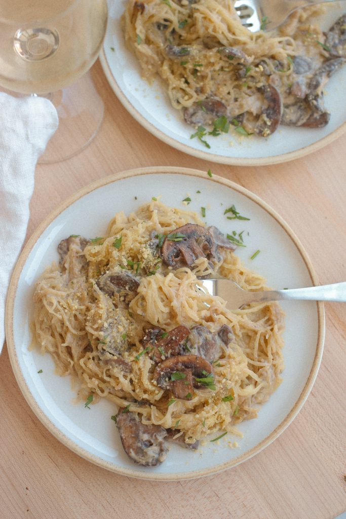 mushroom spaghetti squash on white plates with fork