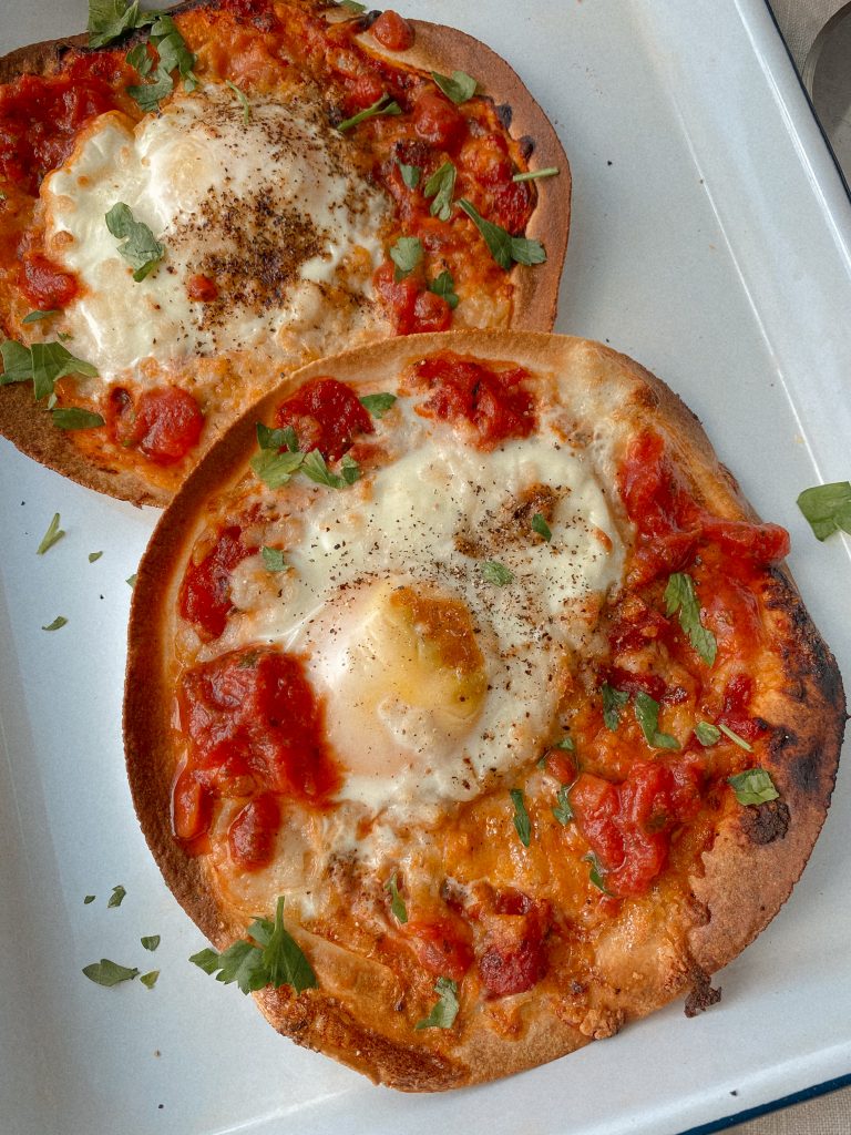 tortilla breakfast pizzas on a white tray