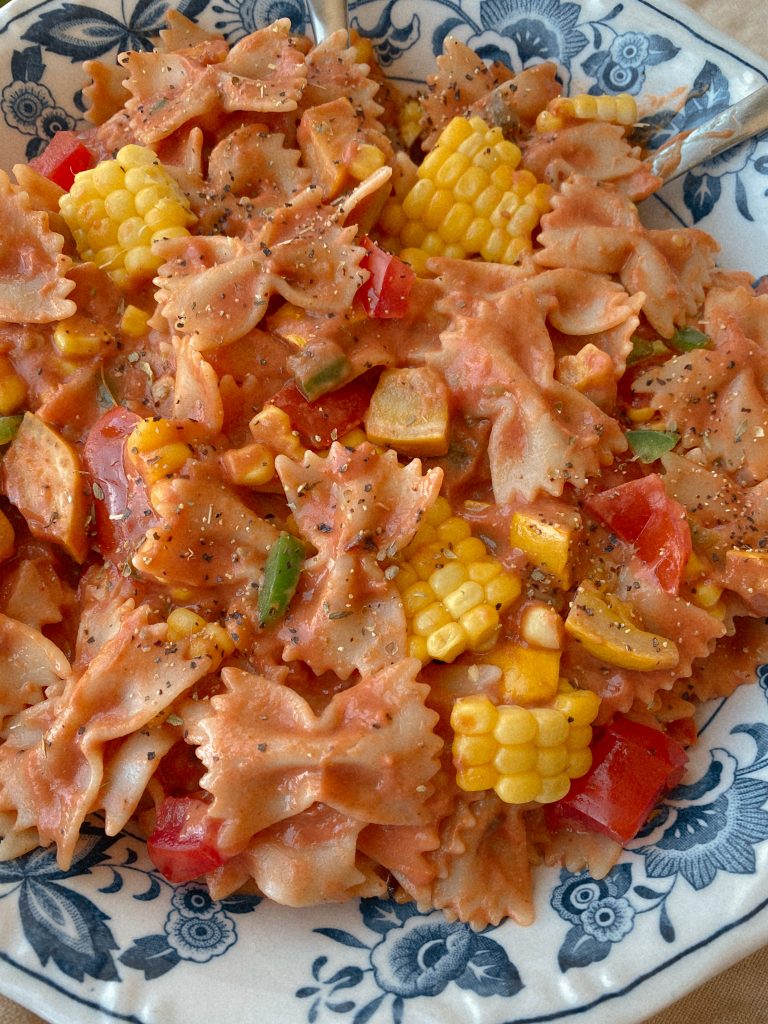 taco pasta with veggies in blue and white bowl