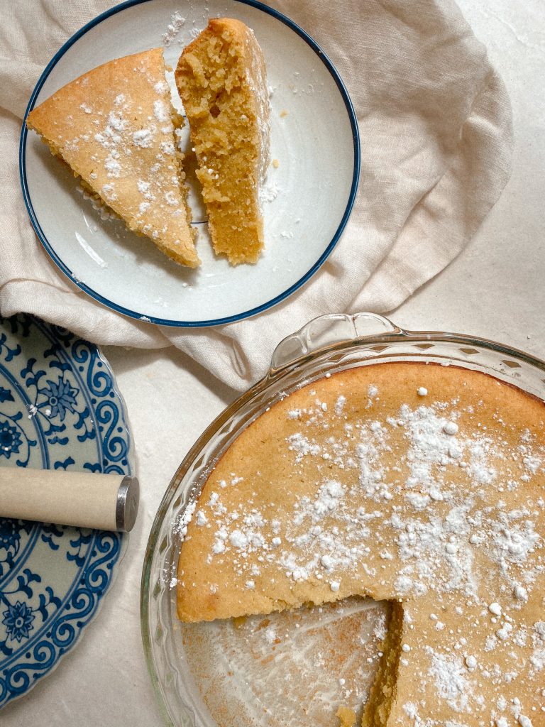 2 slices of lemon cake on plate with cake in pie dish