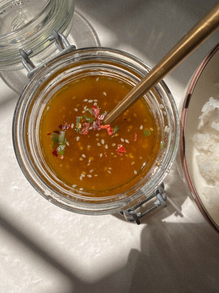 asian vinaigrette in a jar with gold spoon