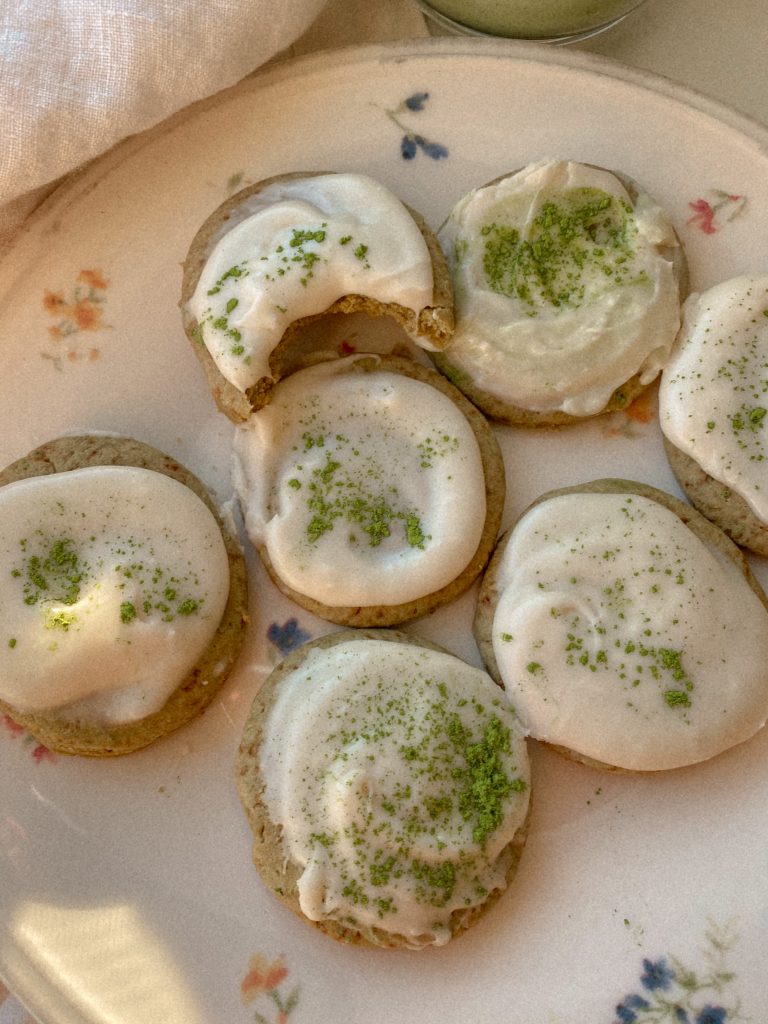 matcha cookies with vanilla frosting on a floral plate 
