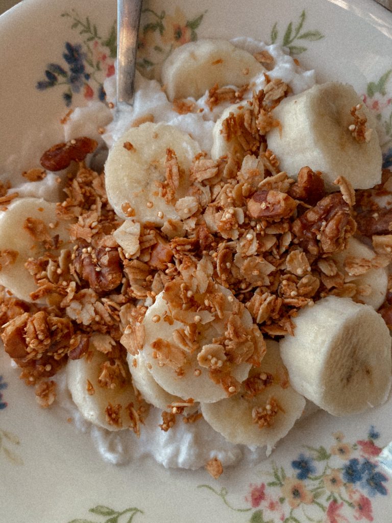vegan, gluten-free walnut granola recipe  topped on yogurt with banana slices. 