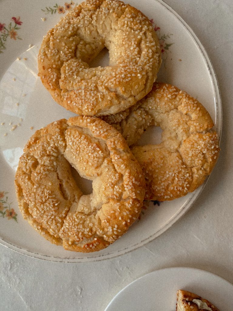 sesame bagels on a white floral plate