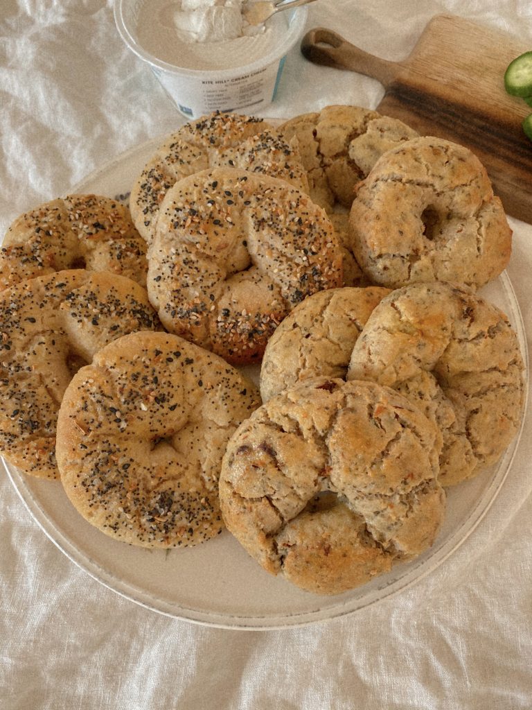 gluten free bagels on a plate with a tub of cream cheese
