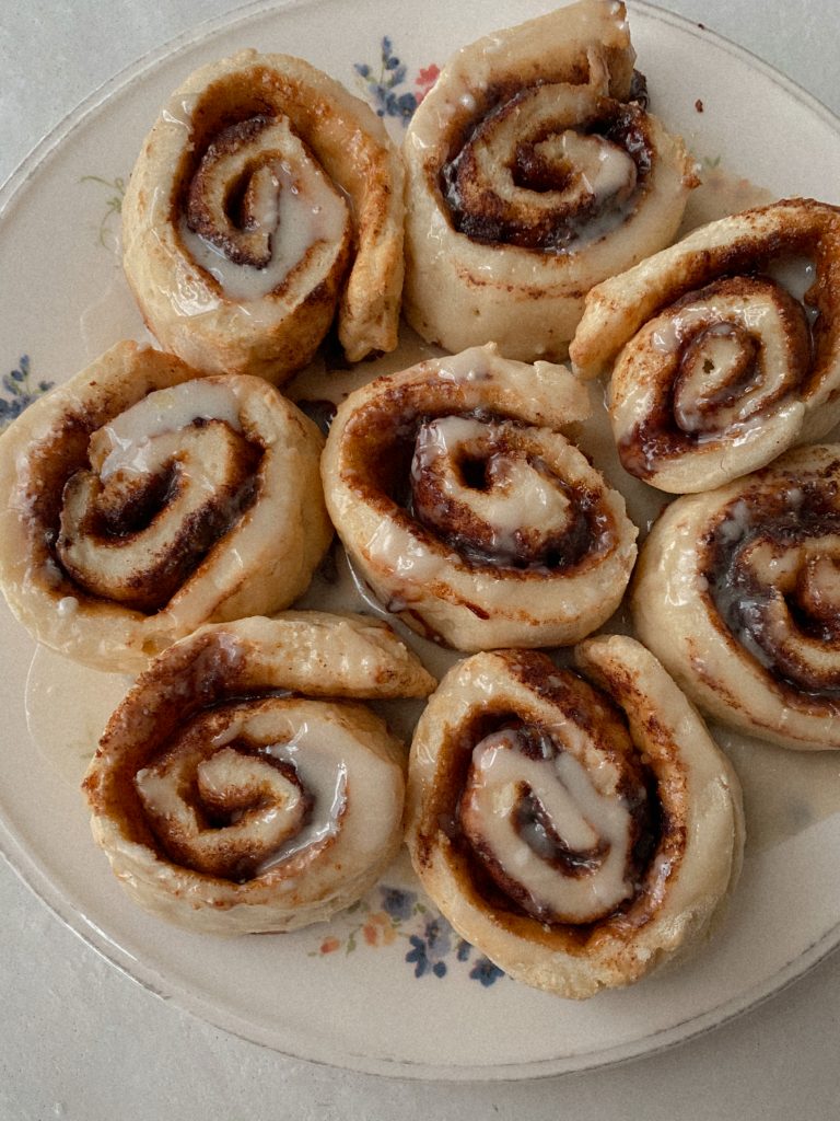 gluten free cinnamon rolls on a white floral plate