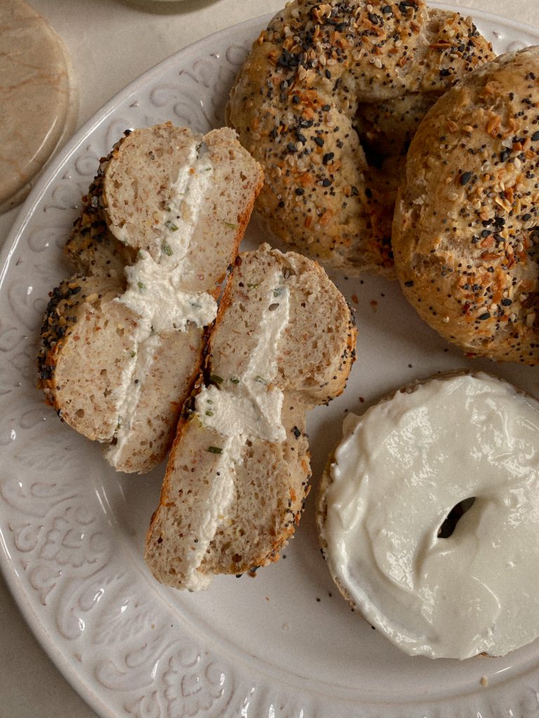 bagels on a white plate with cream cheese 