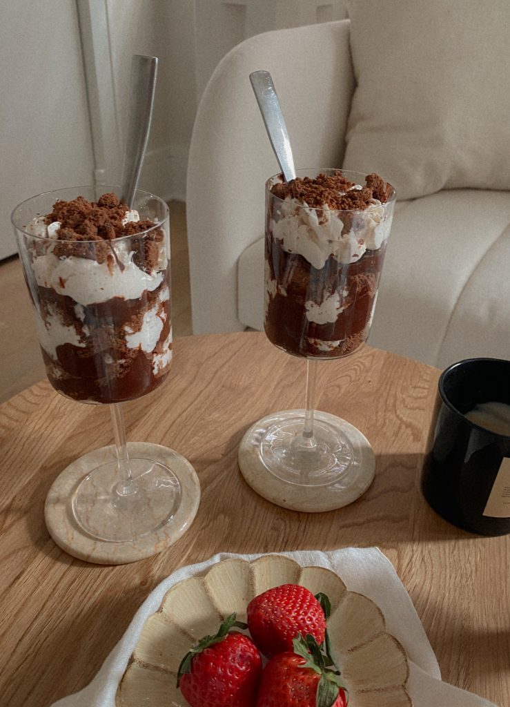 Vegan, Gluten-Free, Dairy-Free, and Paleo Avocado Chocolate Pudding Recipe in a Wine Glass with Coconut Cool Whip and Crushed Chocolate Cookies on Top 