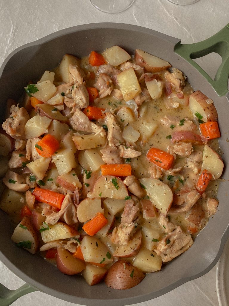 Chicken and Potatoes Skillet Dinner Recipe with Carrots, onion, garlic, and thyme In a skillet